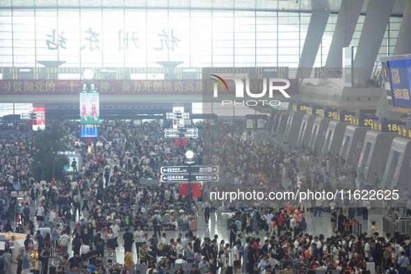 Passengers wait at the waiting hall of Hangzhou East Railway Station in Hangzhou, China, on September 30, 2024. On the day before the Nation...