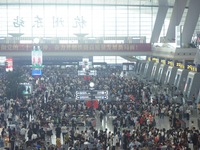 Passengers wait at the waiting hall of Hangzhou East Railway Station in Hangzhou, China, on September 30, 2024. On the day before the Nation...