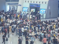 Passengers wait at the waiting hall of Hangzhou East Railway Station in Hangzhou, China, on September 30, 2024. On the day before the Nation...