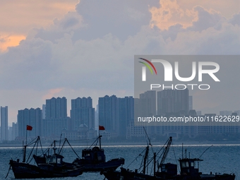 Fishing boats return to the coast of Gujia Island, a new area on the west coast of Qingdao, Shandong province, China, on September 29, 2024....