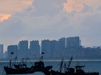 Fishing boats return to the coast of Gujia Island, a new area on the west coast of Qingdao, Shandong province, China, on September 29, 2024....