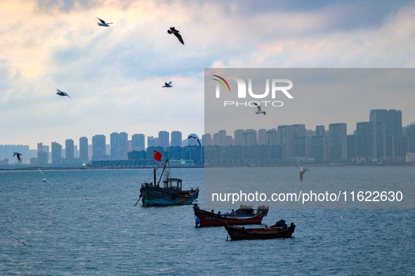 Fishing boats return to the coast of Gujia Island, a new area on the west coast of Qingdao, Shandong province, China, on September 29, 2024....