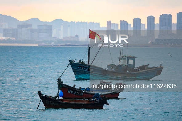 Fishing boats return to the coast of Gujia Island, a new area on the west coast of Qingdao, Shandong province, China, on September 29, 2024....