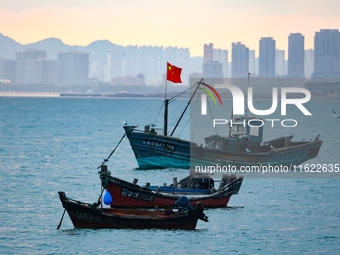 Fishing boats return to the coast of Gujia Island, a new area on the west coast of Qingdao, Shandong province, China, on September 29, 2024....