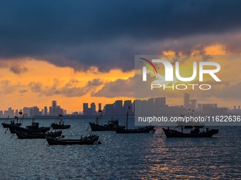 The sunset shines on the beach of Gujia Island in the West Coast New Area of Qingdao, Shandong province, China, on September 29, 2024. (