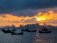 The sunset shines on the beach of Gujia Island in the West Coast New Area of Qingdao, Shandong province, China, on September 29, 2024. (