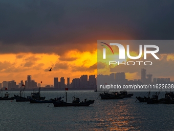 The sunset shines on the beach of Gujia Island in the West Coast New Area of Qingdao, Shandong province, China, on September 29, 2024. (