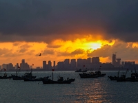 The sunset shines on the beach of Gujia Island in the West Coast New Area of Qingdao, Shandong province, China, on September 29, 2024. (