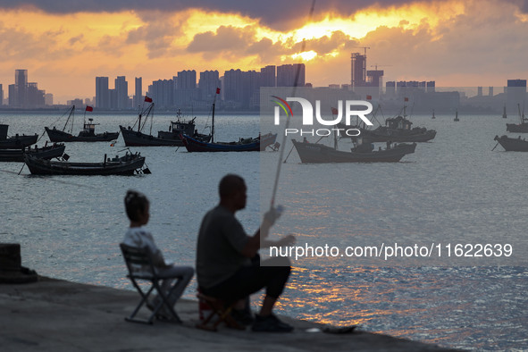 Tourists fish on the beach of Gujia Island in the West Coast New Area of Qingdao, Shandong province, China, on September 29, 2024. 