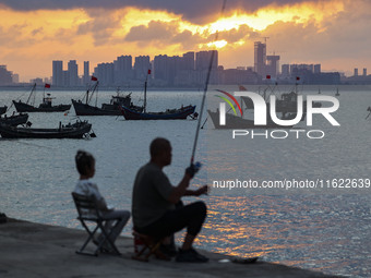 Tourists fish on the beach of Gujia Island in the West Coast New Area of Qingdao, Shandong province, China, on September 29, 2024. (