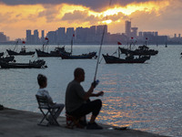 Tourists fish on the beach of Gujia Island in the West Coast New Area of Qingdao, Shandong province, China, on September 29, 2024. (