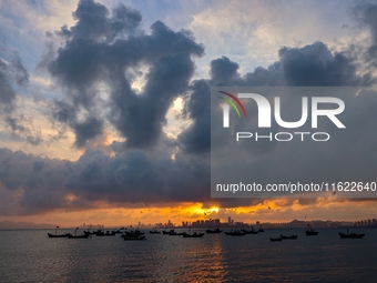 The sunset shines on the beach of Gujia Island in the West Coast New Area of Qingdao, Shandong province, China, on September 29, 2024. (