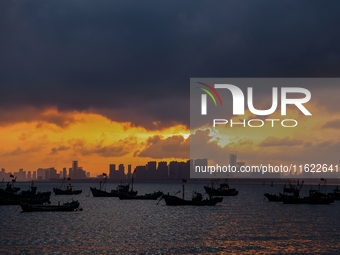 The sunset shines on the beach of Gujia Island in the West Coast New Area of Qingdao, Shandong province, China, on September 29, 2024. (