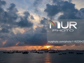 The sunset shines on the beach of Gujia Island in the West Coast New Area of Qingdao, Shandong province, China, on September 29, 2024. (