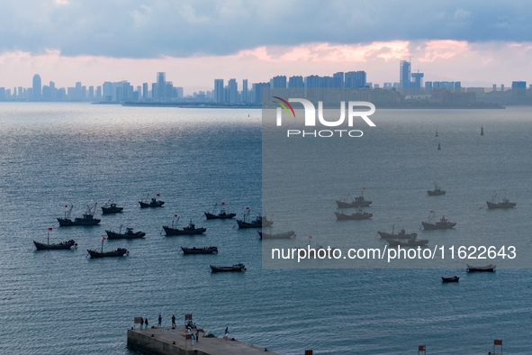 Fishing boats return to the coast of Gujia Island, a new area on the west coast of Qingdao, Shandong province, China, on September 29, 2024....