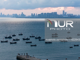 Fishing boats return to the coast of Gujia Island, a new area on the west coast of Qingdao, Shandong province, China, on September 29, 2024....