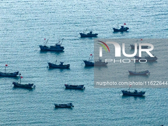 Fishing boats return to the coast of Gujia Island, a new area on the west coast of Qingdao, Shandong province, China, on September 29, 2024....