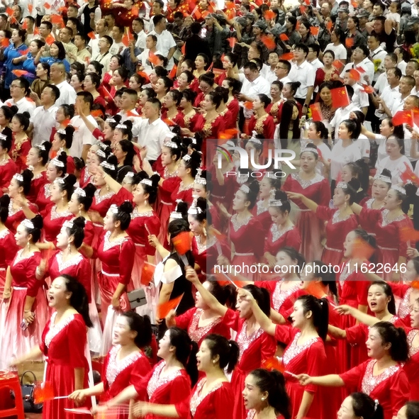 A large number of audience members and actors sing ''Me and My Motherland'' together at the celebration of the 75th anniversary of the found...