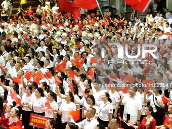 A large number of audience members and actors sing ''Me and My Motherland'' together at the celebration of the 75th anniversary of the found...