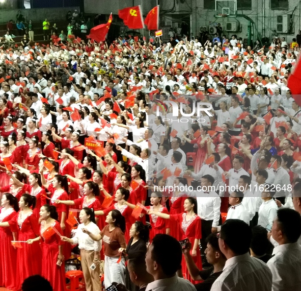 A large number of audience members and actors sing ''Me and My Motherland'' together at the celebration of the 75th anniversary of the found...