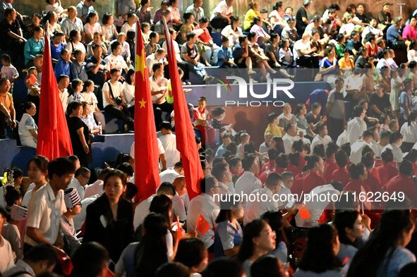 A large number of audience members and actors sing ''Me and My Motherland'' together at the celebration of the 75th anniversary of the found...