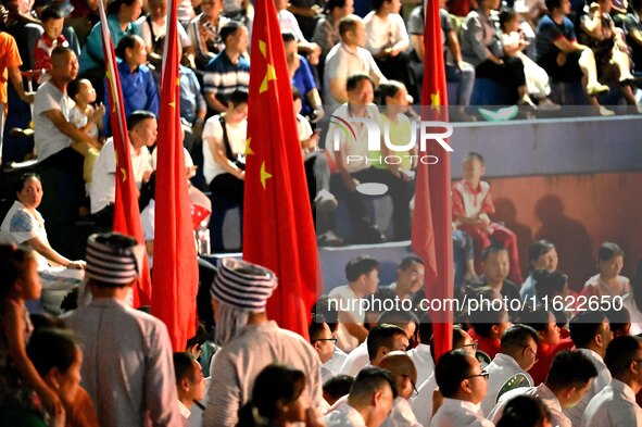 A large number of audience members and actors sing ''Me and My Motherland'' together at the celebration of the 75th anniversary of the found...