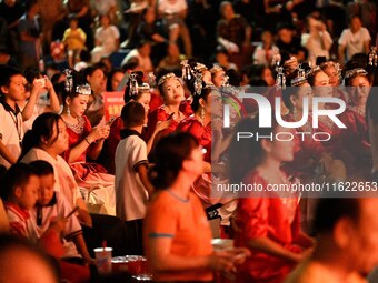 A large number of audience members and actors sing ''Me and My Motherland'' together at the celebration of the 75th anniversary of the found...