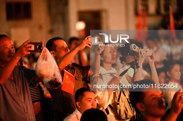 A large number of audience members and actors sing ''Me and My Motherland'' together at the celebration of the 75th anniversary of the found...