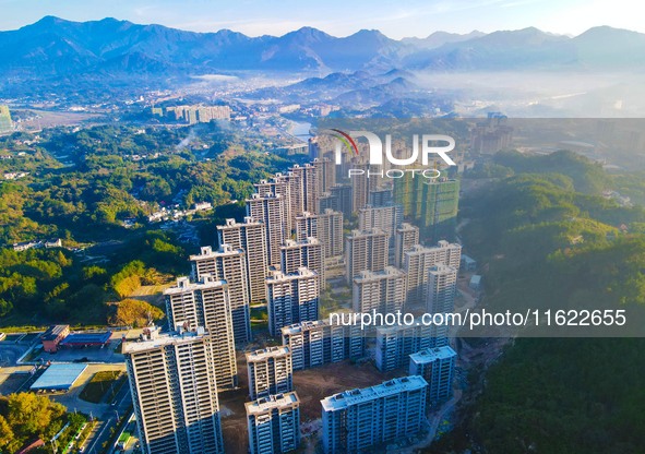 Buildings under construction are seen around the Yesban community in Anqing, China, on September 30, 2024. 