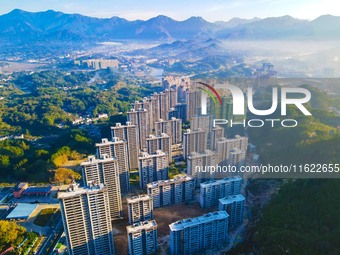 Buildings under construction are seen around the Yesban community in Anqing, China, on September 30, 2024. (