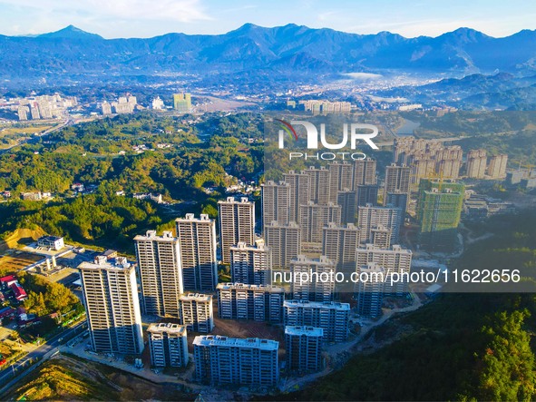 Buildings under construction are seen around the Yesban community in Anqing, China, on September 30, 2024. 