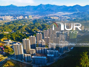 Buildings under construction are seen around the Yesban community in Anqing, China, on September 30, 2024. (