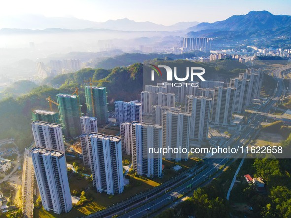 Buildings under construction are seen around the Yesban community in Anqing, China, on September 30, 2024. 