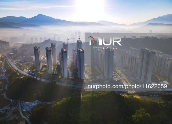 Buildings under construction are seen around the Yesban community in Anqing, China, on September 30, 2024. 