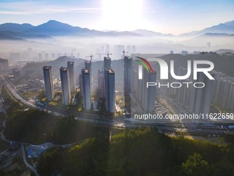 Buildings under construction are seen around the Yesban community in Anqing, China, on September 30, 2024. (