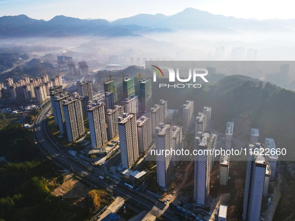 Buildings under construction are seen around the Yesban community in Anqing, China, on September 30, 2024. 