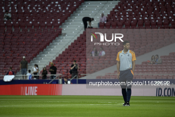 Real Madrid's midfielder Jude Bellingham walks around the pitch before the Spanish league football match between Club Atletico de Madrid and...