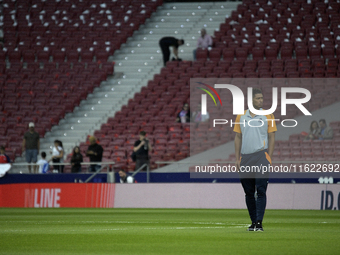 Real Madrid's midfielder Jude Bellingham walks around the pitch before the Spanish league football match between Club Atletico de Madrid and...