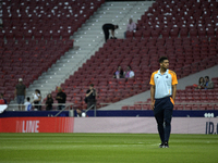 Real Madrid's midfielder Jude Bellingham walks around the pitch before the Spanish league football match between Club Atletico de Madrid and...