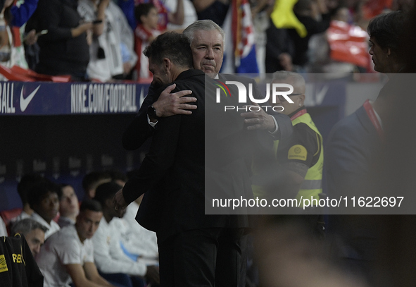 Atletico Madrid's Argentine coach Diego Simeone and Real Madrid's Italian coach Carlo Ancelotti hug each other before the Spanish league foo...