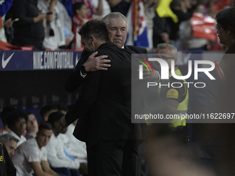 Atletico Madrid's Argentine coach Diego Simeone and Real Madrid's Italian coach Carlo Ancelotti hug each other before the Spanish league foo...