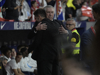 Atletico Madrid's Argentine coach Diego Simeone and Real Madrid's Italian coach Carlo Ancelotti hug each other before the Spanish league foo...