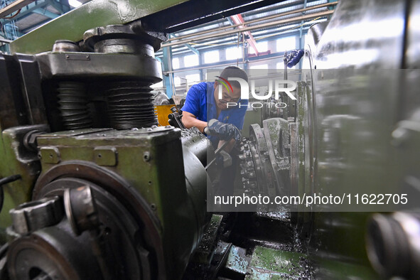 A worker works at an auto gear manufacturing company in Qingzhou Economic Development Zone in Qingzhou, China, on September 30, 2024. On the...