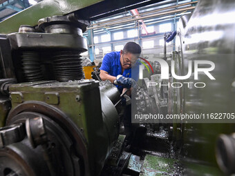 A worker works at an auto gear manufacturing company in Qingzhou Economic Development Zone in Qingzhou, China, on September 30, 2024. On the...