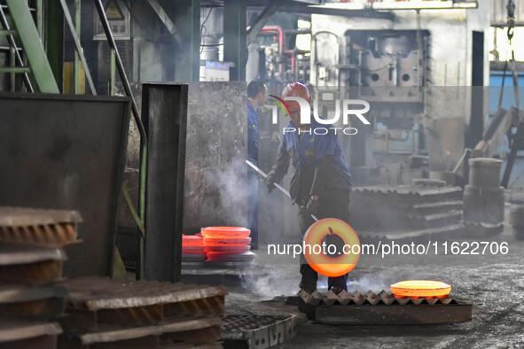 A worker works at an auto gear manufacturing company in Qingzhou Economic Development Zone in Qingzhou, China, on September 30, 2024. On the...