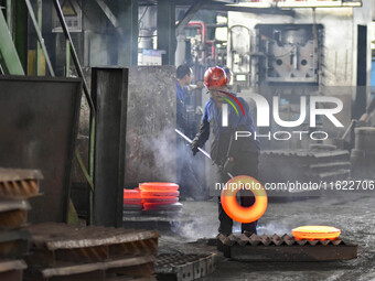 A worker works at an auto gear manufacturing company in Qingzhou Economic Development Zone in Qingzhou, China, on September 30, 2024. On the...