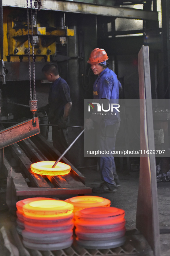 A worker works at an auto gear manufacturing company in Qingzhou Economic Development Zone in Qingzhou, China, on September 30, 2024. On the...