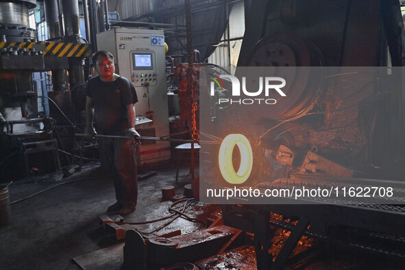 A worker works at an auto gear manufacturing company in Qingzhou Economic Development Zone in Qingzhou, China, on September 30, 2024. On the...