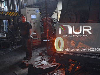 A worker works at an auto gear manufacturing company in Qingzhou Economic Development Zone in Qingzhou, China, on September 30, 2024. On the...