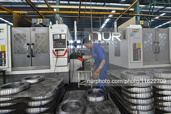 A worker works at an auto gear manufacturing company in Qingzhou Economic Development Zone in Qingzhou, China, on September 30, 2024. On the...